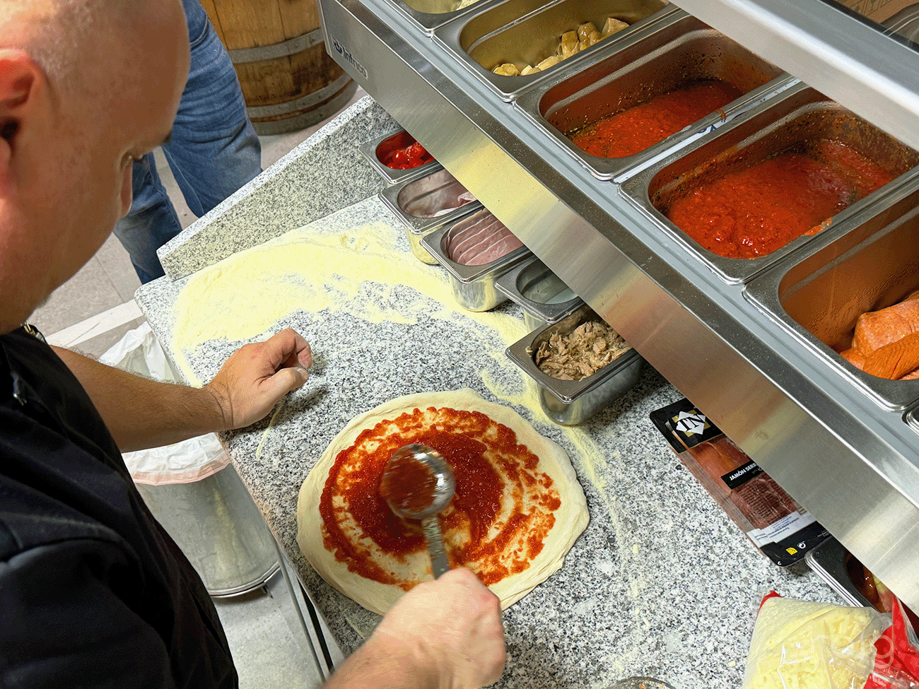 Elaboración de pizza napolitana con tomate durante la formación del horno Zanolli en Grupo Roig.