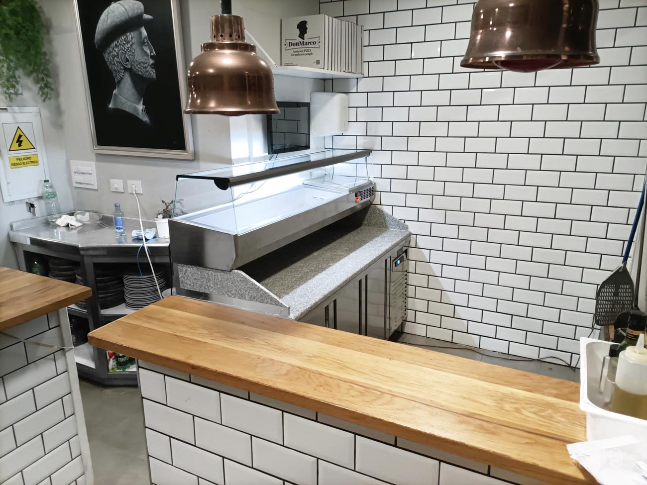 Zona superior de ingredientes en la mesa refrigerada profesional de Pizzería Don Marco